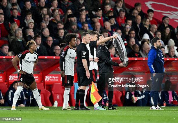 Tom Cairney, Willian and Adama Traore of Fulham are substituted on in the 33rd minute during the Premier League match between Nottingham Forest and...