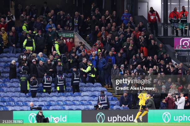 Police and stewards escort fans away from an area of the stand, due to an issue with the stadium roof during the Premier League match between Burnley...