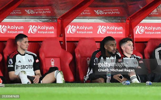 Sasa Lukic, Alex Iwobi and Harry Wilson of Fulham react after being substituted off during the Premier League match between Nottingham Forest and...
