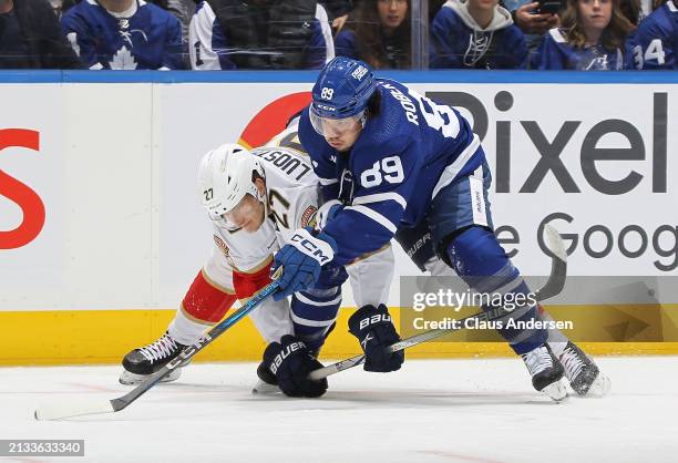 Eetu Luostarinen of the Florida Panthers battles against Nicholas Robertson of the Toronto Maple Leafs during the second period in an NHL game at...