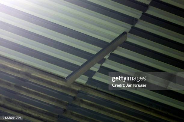 Detailed view of a loose piece of metal hanging from the stadium roof, as fans were moved due to safety concerns during the Premier League match...