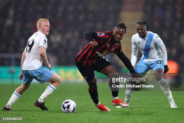 Antoine Semenyo of AFC Bournemouth is challenged by Will Hughes and Eberechi Eze of Crystal Palace during the Premier League match between AFC...