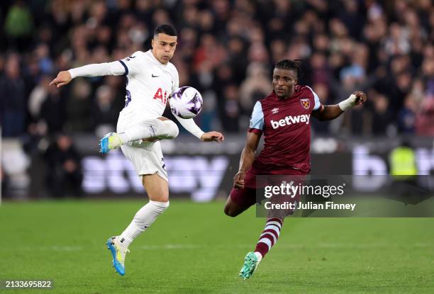 Pedro Porro of Tottenham Hotspur is challenged by Mohammed Kudus of West Ham United during the Premier League match between West Ham United and...