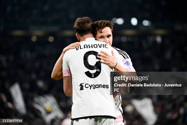 Federico Chiesa of Juventus celebrates after scoring his team's first goal with teammate Dusan Vlahovic during the Coppa Italia Semi-final match...