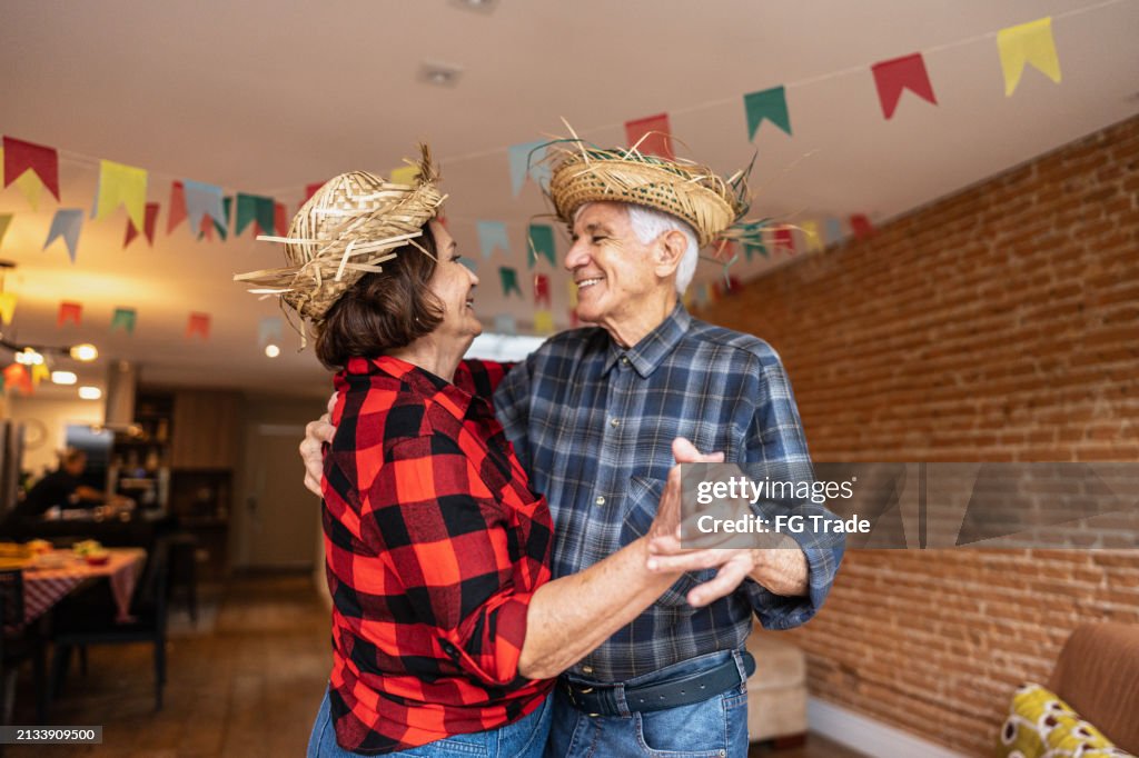 Senior couple dancing on a brazilian Junina party