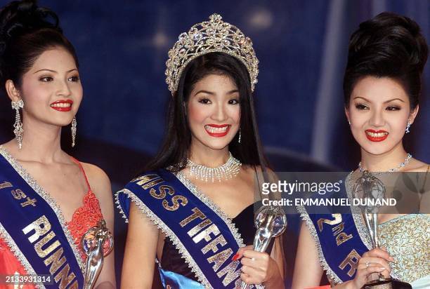 Twenty-year old Chanya Moranon stands with her trophy next to first runner-up Nitchanon Sutprasert and second runner-up Tatsaneewan Tanyasiri after...