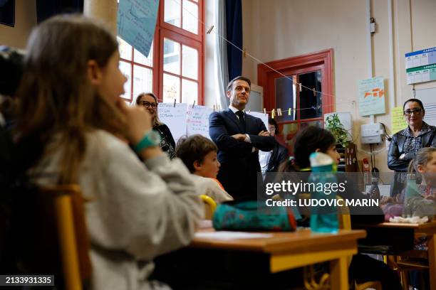 French President Emmanuel Macron and France's Deputy Minister for the Elderly and the Disabled Fadila Khattabi meet with Third Grade pupils during a...