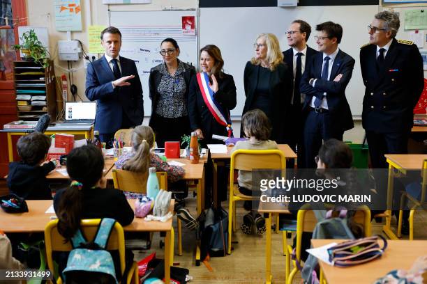 French President Emmanuel Macron, France's Deputy Minister for the Elderly and the Disabled Fadila Khattabi, mayor of Paris' 9th district Delphine...