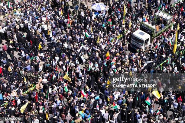 People attend the funeral procession for seven Islamic Revolutionary Guard Corps members killed in a strike in Syria, which Iran blamed on Israel, in...