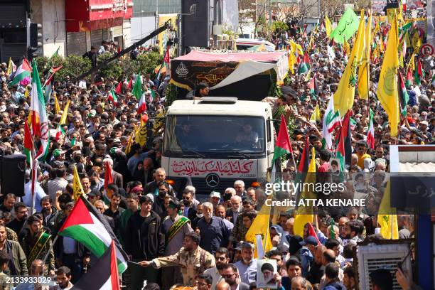 People attend the funeral procession for seven Islamic Revolutionary Guard Corps members killed in a strike in Syria, which Iran blamed on Israel, in...