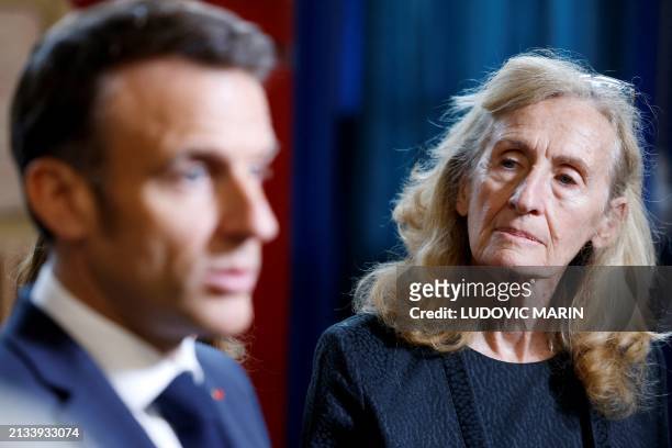 France's Minister for Education and Youth Nicole Belloubet listens to French President Emmanuel Macron as he addresses the media during a visit to...