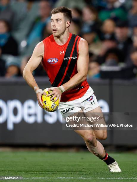 Zach Merrett of the Bombers in action during the 2024 AFL Round 04 match between the Port Adelaide Power and the Essendon Bombers at Adelaide Oval on...