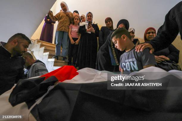 Mourners carry the body of Palestinian Saed Abu Alawiyah, who was killed during an Israeli raid on the Nur Shams camp, during his funeral at the camp...