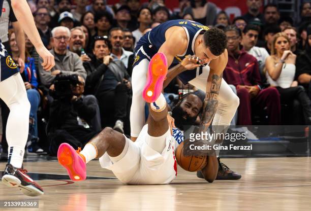 Denver Nuggets forward Michael Porter Jr. Ties up LA Clippers guard James Harden to force a jump ball in the first half at Crypto.com Arena on April...