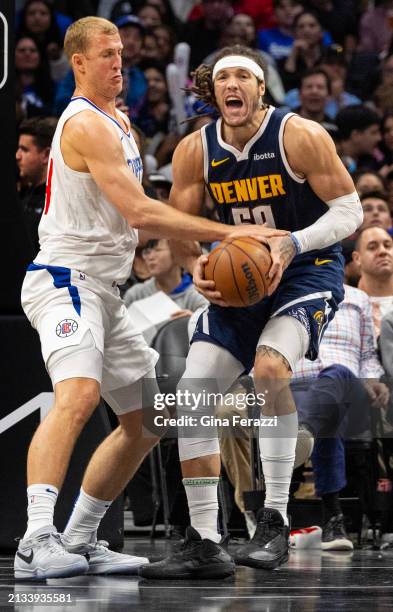 Clippers center Mason Plumlee plays aggressive defense on Denver Nuggets forward Aaron Gordon and is called for a foul in the second half at...