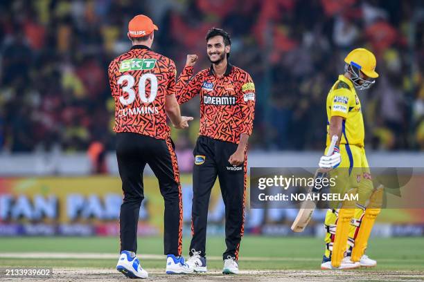 Sunrisers Hyderabad's Shahbaz Ahmed celebrates with his captain Pat Cummins after taking the wicket of Chennai Super Kings' captain Ruturaj Gaikwad...