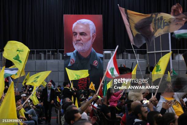 Hezbollah supporters carry a portrait of slain Iran's al-Quds brigade commander Qassem Suliemani during a gathering to mark annual Quds Day...