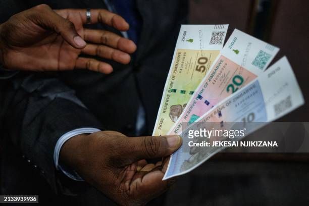 Zimbabwe Reserve Bank Governer John Mushayavanhu presents his monetary policy statement during which he announced the launch by the central bank of...
