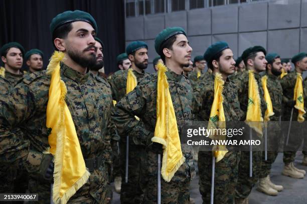 Hezbollah members stand in formation during a gathering to mark annual Quds Day commemorations in Beirut's southern suburb on April 5, 2024.