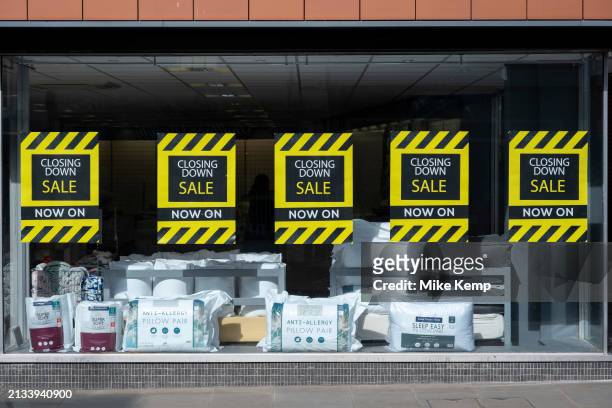 Closing down sale posters in the window of a retail space, another example of the decline of the UK high street on 2nd April 2024 in Gloucester,...