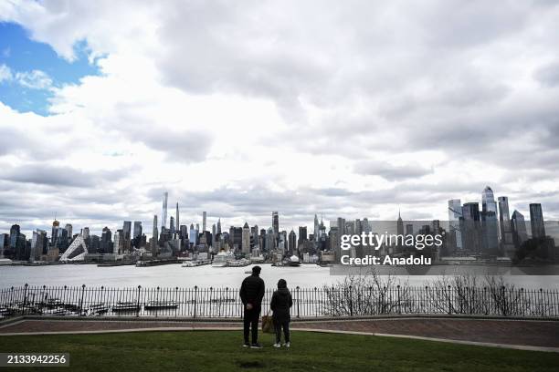 People wait outside after a 4.8 magnitude earthquake which shook the northeastern US states of New Jersey and New York, according to the United...