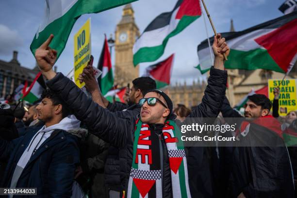 Man gestures at pro-Israel supporters during a march to mark Al Quds Day and show solidarity with Palestinians on April 5, 2024 in London, England....