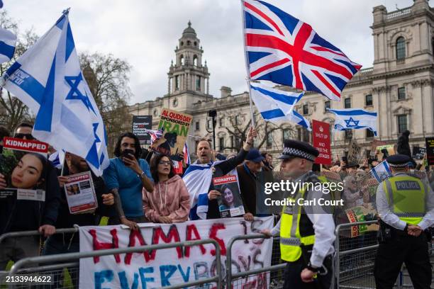 Pro-Israel supporters demonstrate as people pass by on a march to celebrate Al Quds Day and show solidarity with Palestinians on April 5, 2024 in...