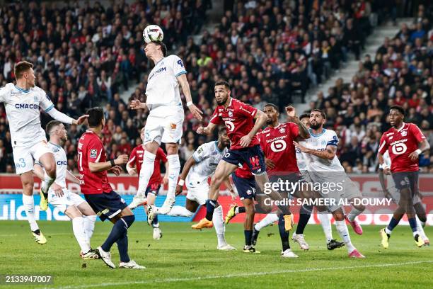 Marseille's Italian Argentinian defender Leonardo Balerdi heads the ball during the French L1 football match between Lille LOSC and Olympique...