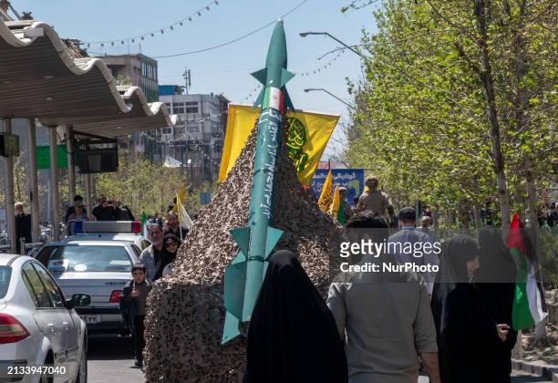 Truck is carrying an Iranian missile during a rally commemorating International Quds Day, also known as Jerusalem Day, and a funeral for members of...