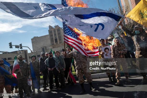 Members of the Islamic Revolutionary Guard Corps are burning flags of Israel and the U.S. During a funeral for members of the IRGC Quds Force who...