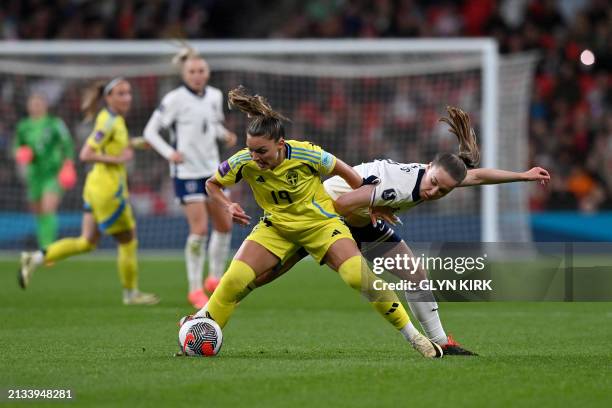 Sweden's midfielder Johanna Rytting Kaneryd fights for the ball with England's defender Niamh Charles during the Women's UEFA Euro 2025 League A...