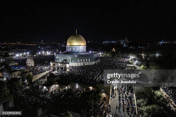 Palestinians perform Tarawih prayer after breaking their fasts at the courtyard on the Islamic holy night of Laylat al-Qadr at the Dome of the Rock...
