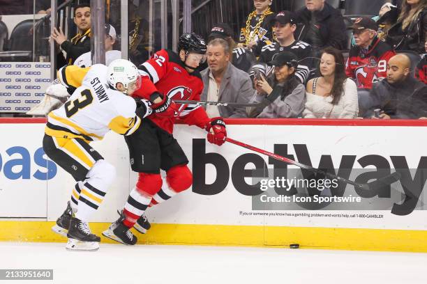 New Jersey Devils center Curtis Lazar skates by Pittsburgh Penguins defenseman Jack St. Ivany during a game between the Pittsburgh Penguins and New...