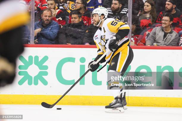 Pittsburgh Penguins defenseman Kris Letang skates with the puck during a game between the Pittsburgh Penguins and New Jersey Devils on April 2, 2024...