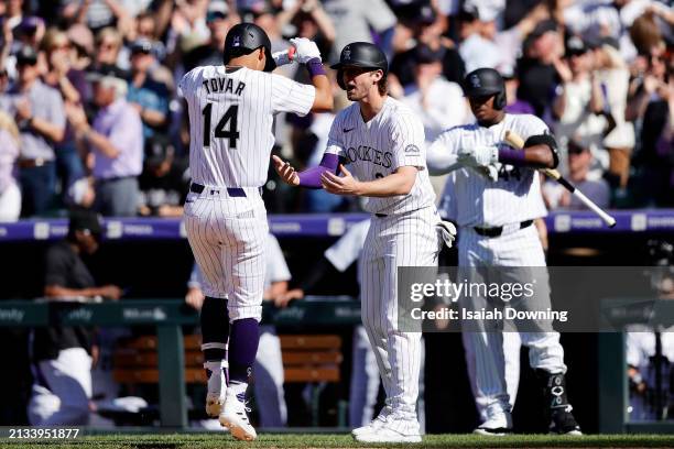 Ezequiel Tovar of the Colorado Rockies celebrates with Ryan McMahon after hitting a two-run home run in the sixth inning during the game between the...