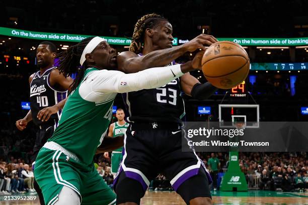 Jrue Holiday of the Boston Celtics reaches in to knock the ball away from Keon Ellis of the Sacramento Kings during the first quarter at TD Garden on...