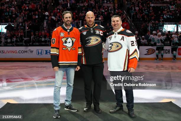 Ryan Miller, Ryan Getzlaf and Francois Beauchemin pose for a photo during the ceremonial puck drop on Legacy Night prior to the game between the...