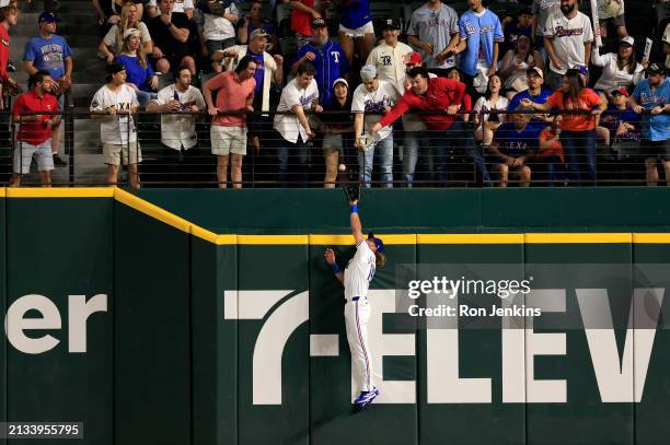 Travis Jankowski of the Texas Rangers attempts to catch a two home run off the bat of Jake Meyers of the Houston Astros during the eighth inning at...