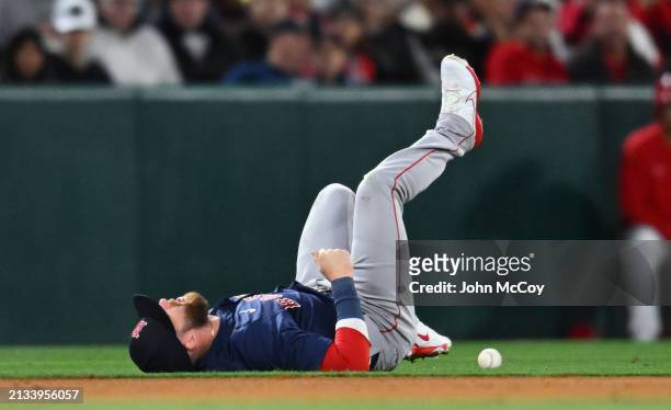 Trevor Story of the Boston Red Sox reacts after being injured going after a ball hit by Mike Trout of the Los Angeles Angels in the fourth inning...