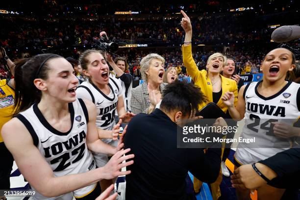 The Iowa Hawkeyes celebrate after the game against the UConn Huskies during the NCAA Women's Basketball Tournament Final Four semifinal game at...