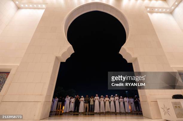 Men pray at the Sheikh Zayed Grand Mosque in Abu Dhabi in the early hours of April 6 on Laylat al-Qadr , one of the holiest nights during the Muslim...