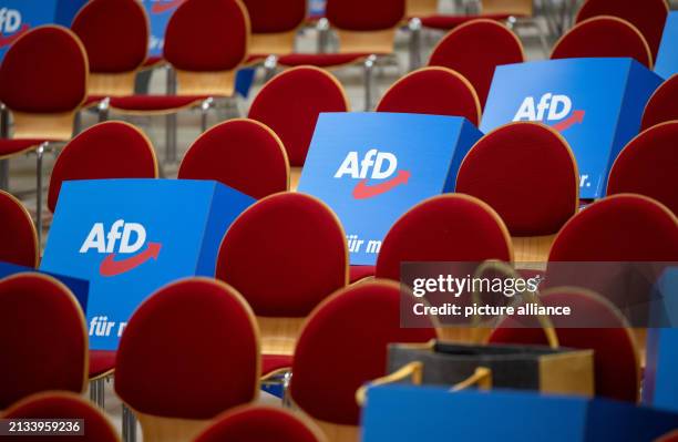 April 2024, Brandenburg, Jüterbog: Cardboard stands with the AfD logo lie on the chairs in the Wiesenhalle before the start of the AfD Brandenburg...