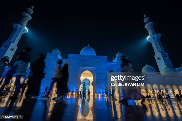 Women arrive to pray at the Sheikh Zayed Grand Mosque in Abu Dhabi in the early hours of April 6 on Laylat al-Qadr , one of the holiest nights during...