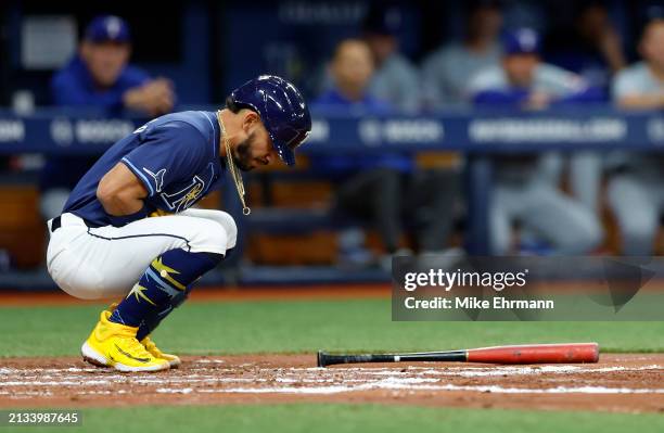 Jose Caballero of the Tampa Bay Rays reacts after being hit by a pitch in the third inning during a game against the Texas Rangers at Tropicana Field...