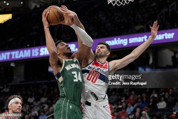 Giannis Antetokounmpo of the Milwaukee Bucks goes up against Tristan Vukcevic of the Washington Wizards during the first half at Capital One Arena on...