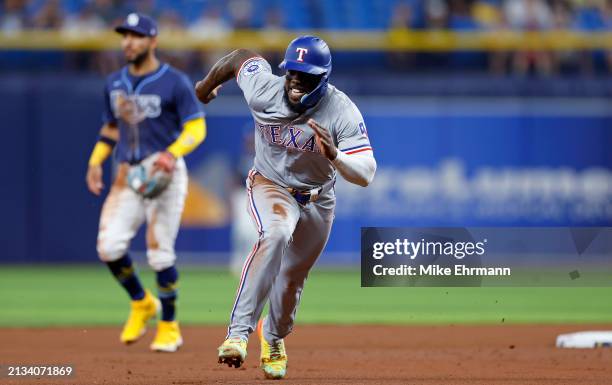 Adolis Garcia of the Texas Rangers runs to third in the seventh inning during a game against the Tampa Bay Rays at Tropicana Field on April 02, 2024...