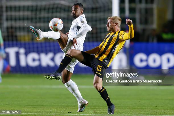 Everton of Gremio battles for possession with Maximiliano Caire of The Strongest during the Copa CONMEBOL Libertadores Group C match between The...