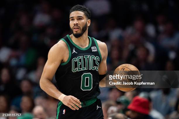 Jayson Tatum of the Boston Celtics brings the ball up court against the Charlotte Hornets during their game at Spectrum Center on April 01, 2024 in...