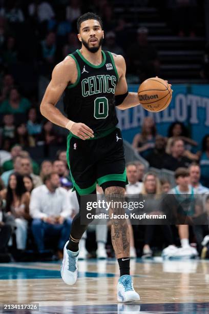 Jayson Tatum of the Boston Celtics brings the ball up court against the Charlotte Hornets during their game at Spectrum Center on April 01, 2024 in...