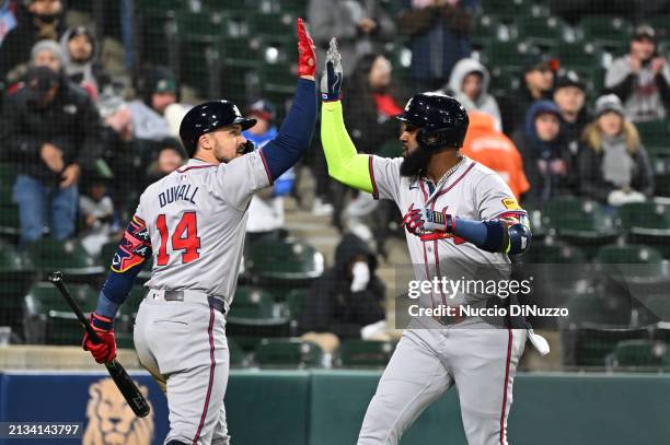 Marcell Ozuna of the Atlanta Braves is congratulated by Adam Duvall of the Atlanta Braves following a home run during the seventh inning of a game...